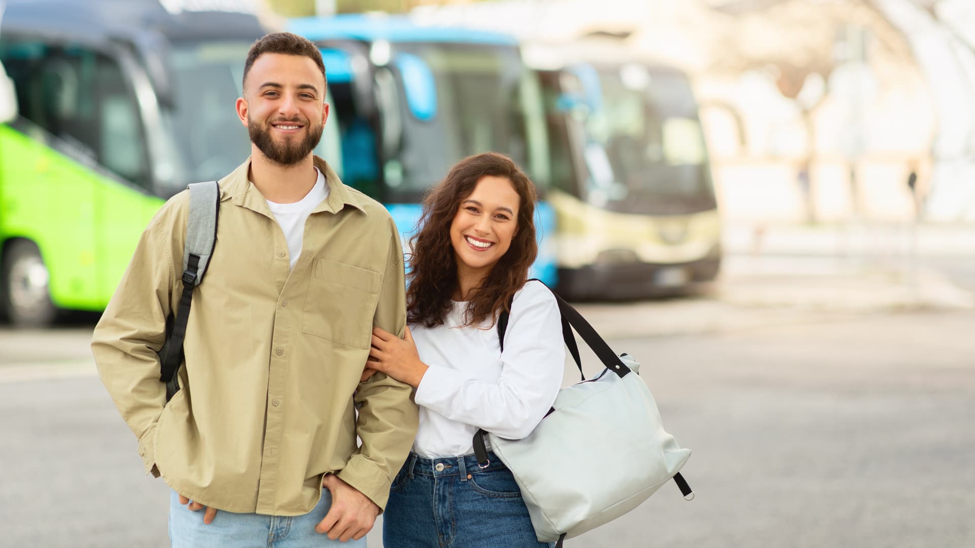 cheerful-young-couple-with-luggage-standing-in-fro-2025-03-18-19-09-23-utc.jpg