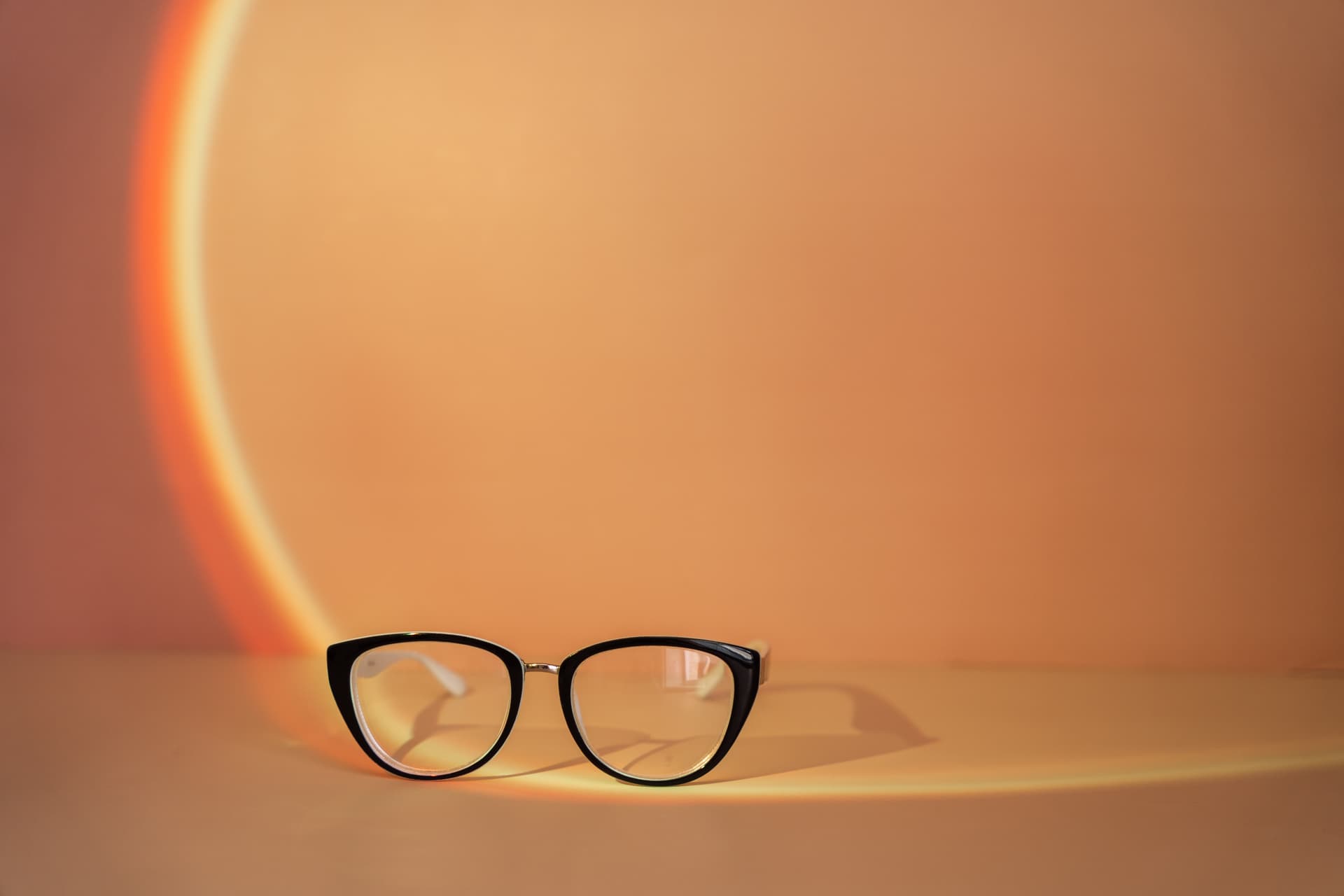 vision-glasses-with-black-frames-under-orange-ligh-2025-02-16-03-50-34-utc.jpg