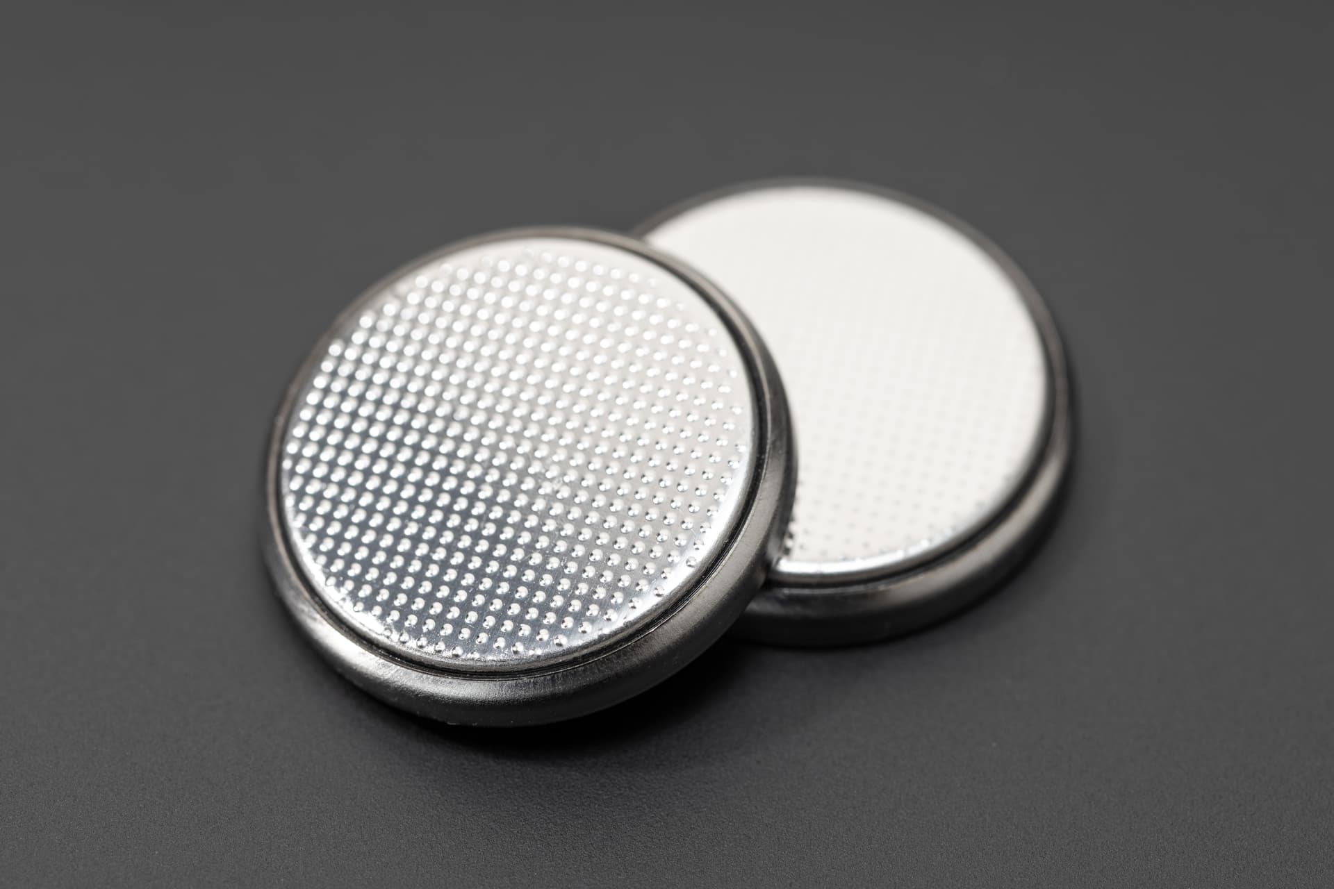 button-cell-battery-isolated-on-black-background-2026-01-08-05-59-02-utc.jpg