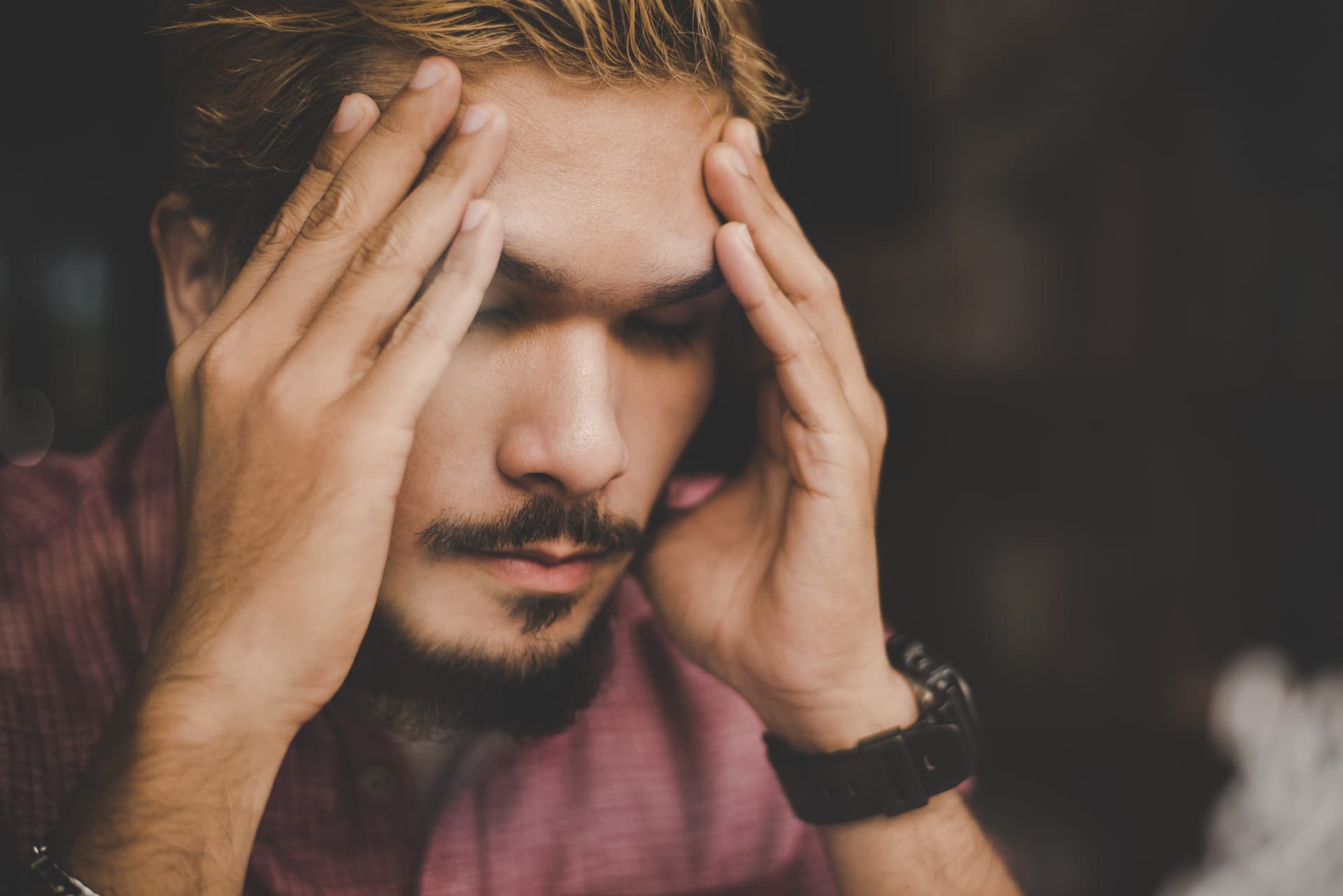 young-hipster-man-hand-his-head-looks-seriously-thinking-while-sitting-cafe.jpg