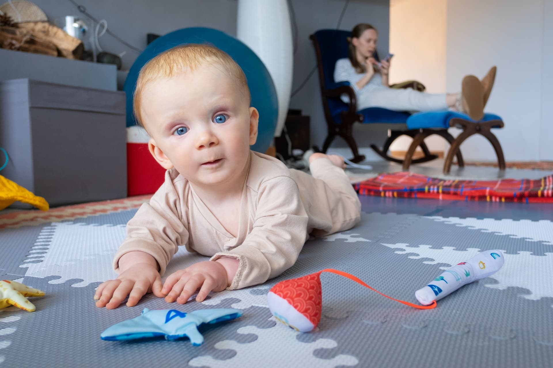 sweet-blue-eyed-baby-playing-floor-toys.jpg