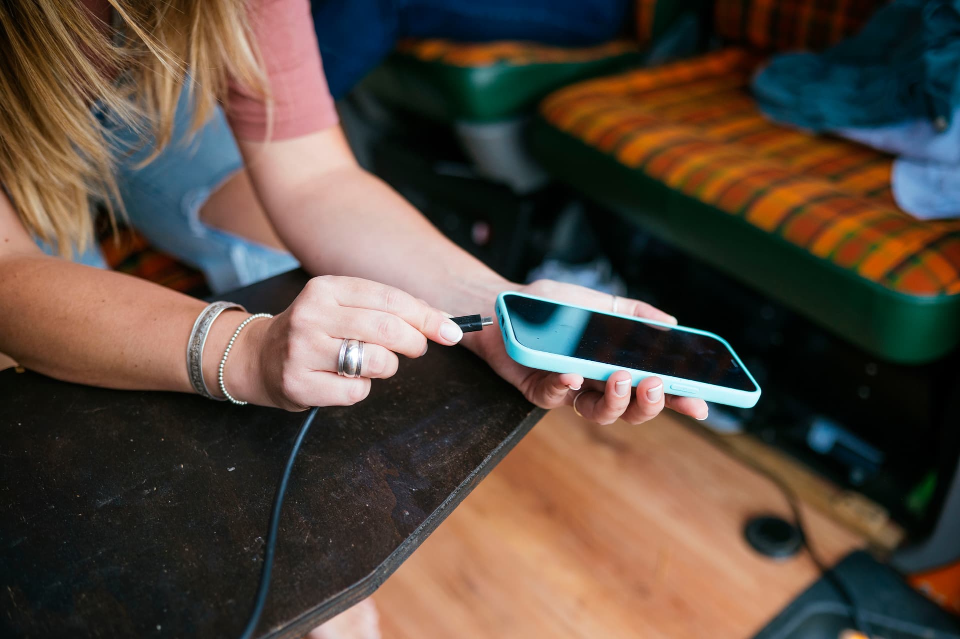 woman-charges-phone-indoors-on-portable-table-2026-03-26-03-33-46-utc.jpg