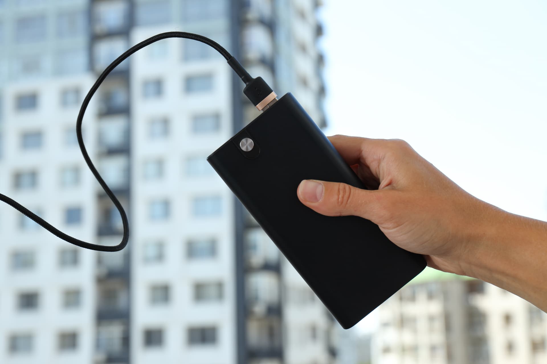 hand-holding-black-power-bank-charging-device-2026-01-09-07-21-16-utc.jpg